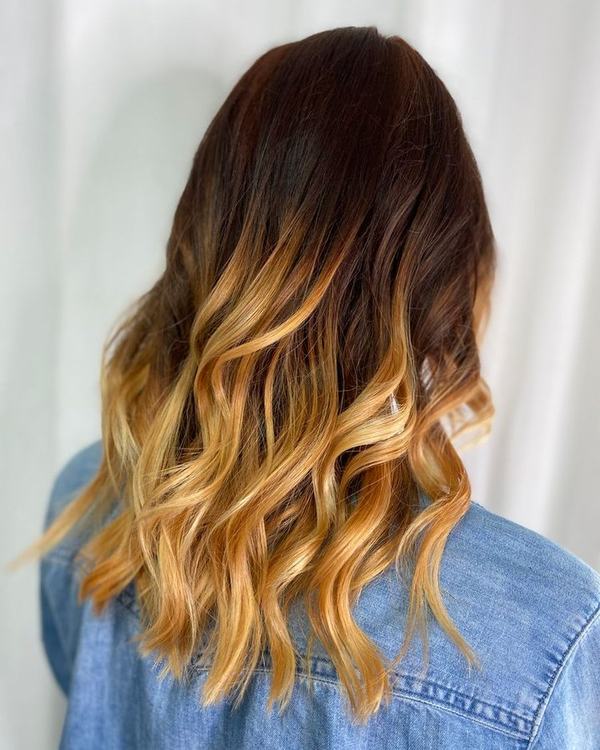 Golden balayage with dimensional waves, seen from the back